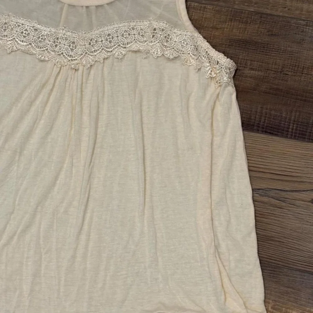 Cream lace tank top with sheer mesh and lace trim on the shoulders